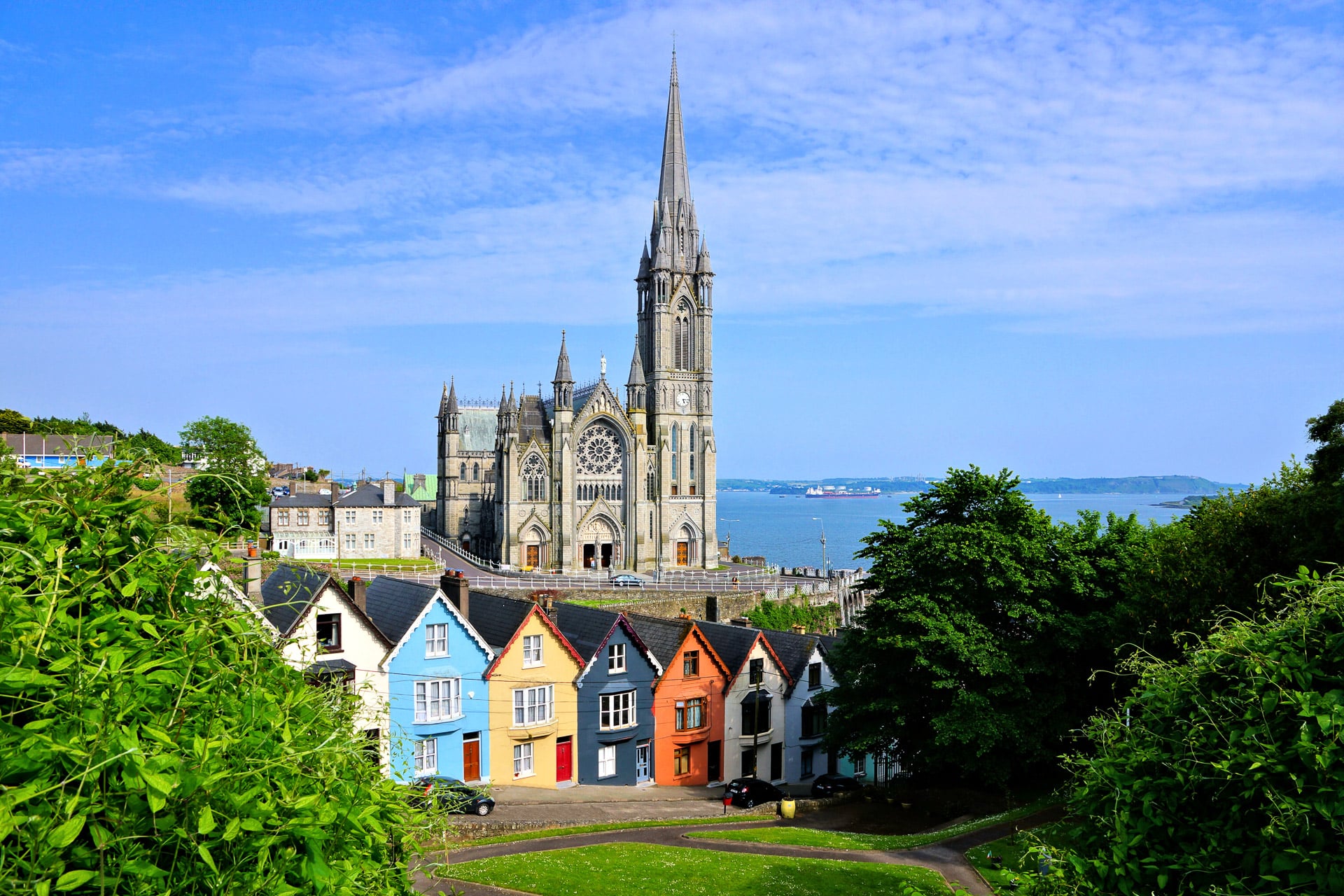 Colorful,Row,Houses,With,Towering,Cathedral,In,Background,In,The